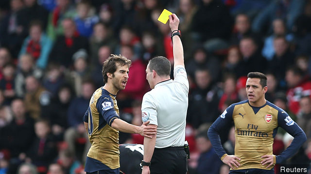 Arsenal's Mathieu Flamini is shown a yellow card by referee Kevin Friend