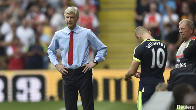 Arsenal's Jack Wilshere waits to come on as manager Arsene Wenger looks