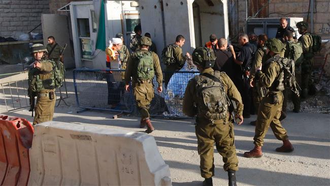 Israeli forces cover the body of a Palestinian who was shot dead near the illegal settler enclave of Tal Rumeda in al Khalil in the occupied West Bank