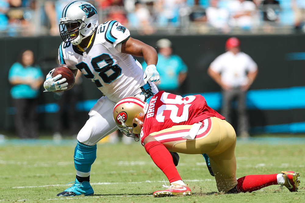 San Francisco 49ers cornerback Tramaine Brock brings down Carolina Panthers running back Jonathan Stewart during the first quarter at Bank of America Stadium in Charlotte NC