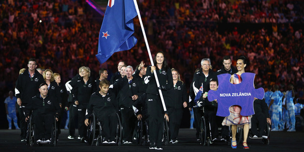 Flag bearer Holly Robinson of New Zealand leads the team entering the stadium during the Opening Ceremony of the Rio 2016 Paralympic Games