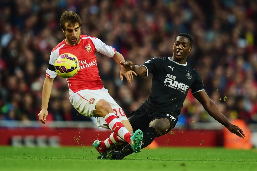 LONDON ENGLAND- NOVEMBER 01 Mathieu Flamini of Arsenal is tackeld by Marvin Sordell of Burnley during the Barclays Premier League match between Arsenal and Burnley at Emirates Stadium