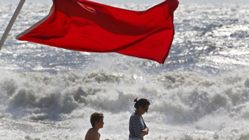 Beachgoers walk away from big waves and rough surf caused by Hermine Sunday Sept. 4 2016 in Bradley Beach,N.J. No swimming was allowed because of the passing storm