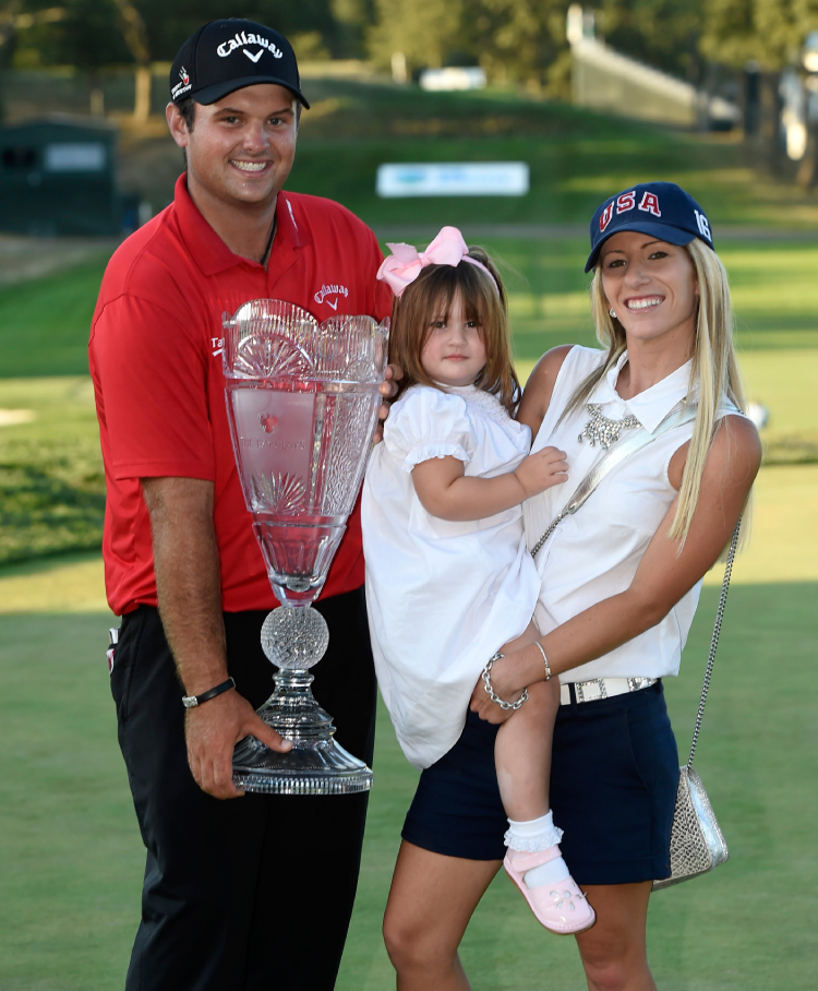 Patrick Reed holds The Barclays trophy together with his wife Justine and daughter in Farmingdale New York, Sunday. — AP