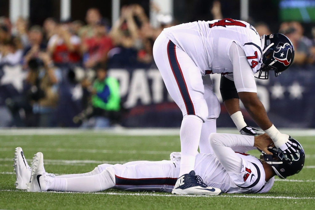 FOXBORO MA- SEPTEMBER 22 Chris Clark #74 of the Houston Texans checks on Brock Osweiler #17 during the second half of their game against the New England Patriots at Gillette Stadium