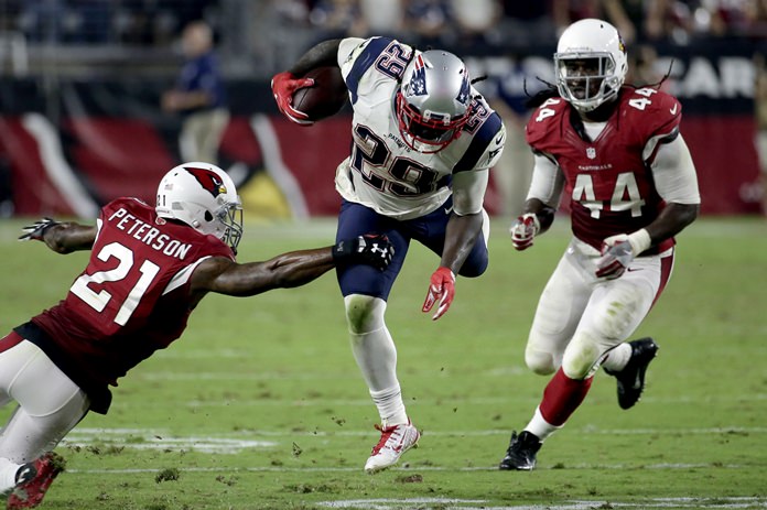 New England Patriots running back Le Garrette Blount is hit by Arizona Cardinals cornerback Patrick Peterson during the second half of their NFL football game Sunday Sept. 11 in Glendale Ariz