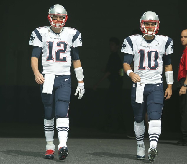 New England Patriots quarterbacks Tom Brady and Jimmy Garoppolo enter the field before an NFL football gam