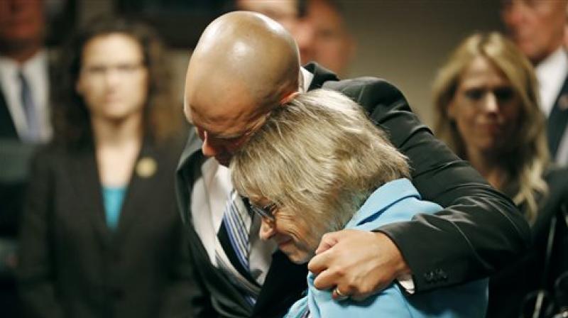 Patty Wetterling the mother of the murdered boy is consoled by her other son