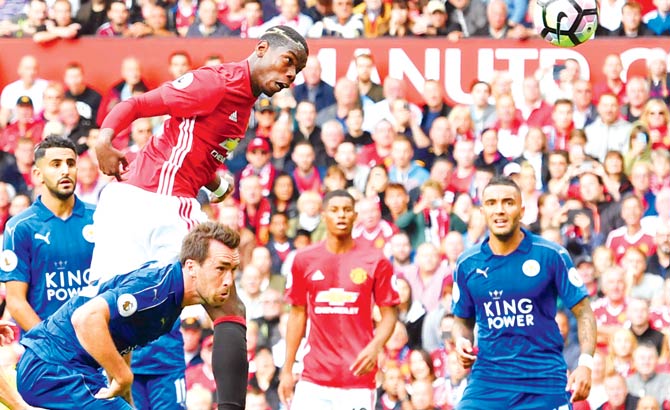 Paul Pogba heads in Manchester United's fourth goal during their EPL match against Leicester City at Old Trafford on Saturday. Pic  AFP