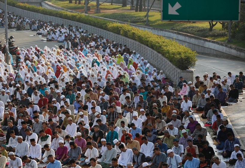 People attend prayers for the Muslim holiday of Aidiladha on a street in Jakarta Indonesia