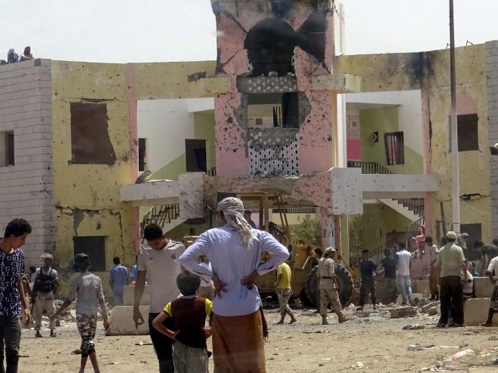 People gather at the scene following an attack by a suicide bomber who drove a bomb car in Yemen