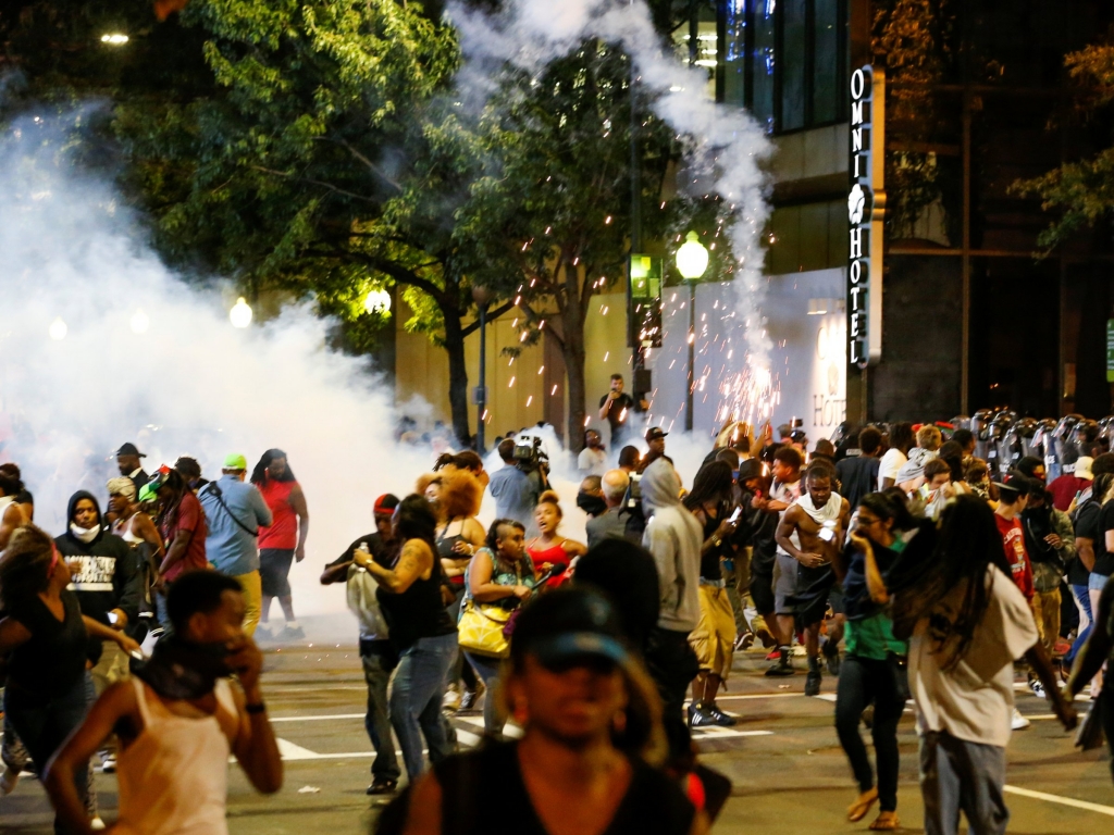 People run from flash-bang grenades in uptown Charlotte during a protest of the police shooting of Keith Scott.   Reuters  Jason Miczek