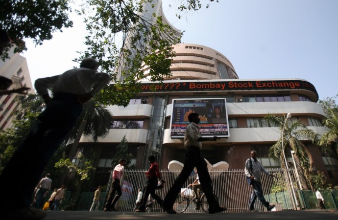 People walk past the Bombay Stock Exchange building in Mumbai