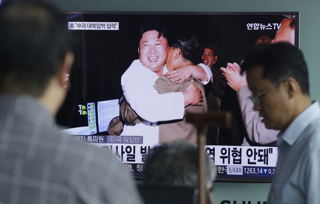 People watch a TV news program showing North Korean leader Kim Jong-un after a ballistic missile test on Aug. 25  2016.    AP