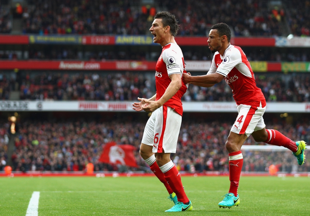 LONDON ENGLAND- SEPTEMBER 10 Laurent Koscielny of Arsenal celebrates scoring his sides first goal with his team mates during the Premier League match between Arsenal and Southampton at Emirates Stadium