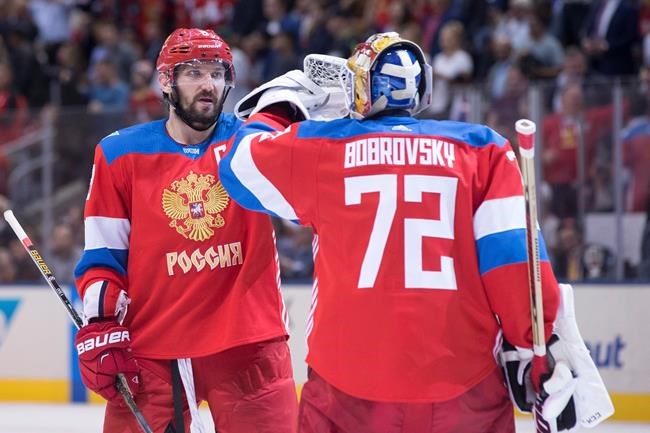 Team Russia's Alex Ovechkin left congratulates goaltender Sergei Bobrovsky on his shutout at the final buzzer as their team beat Team Finland 3-0 in World Cup of Hockey action in Toronto on Thursday