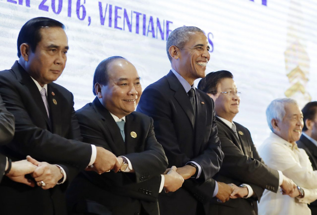 President Obama does an ASEAN-style handshake before the start of the 4th ASEAN-U.S. Summit Meeting at National Convention Center in Vientiane Laos Thursday. From left Thailand's Prime Minister Prayuth Chan-ocha Vietnam's Prime Minister Nguyen Xuan Ph