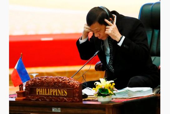 Philippines President Rodrigo Duterte adjusts his headset at the start of the retreat session in the ongoing 28th and 29th ASEAN Summits at the National Convention Center Wednesday Sept. 7 2016 in Vientiane Laos