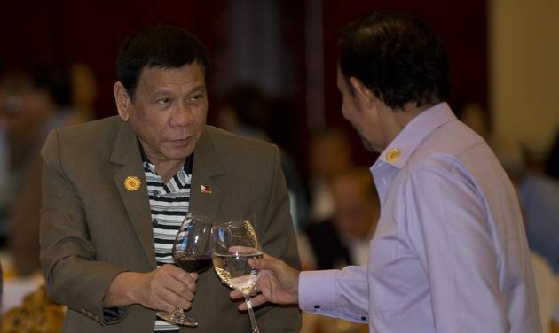 Philippine's President Rodrigo Duterte toasts a drink with Brunei Foreign Minister and Prime Minister Sultan Hassanal Bolkiah during Association of Southeast Asian Nations summit welcome dinner in Vientiane Laos Tuesday Sept. 6 2016. (AP