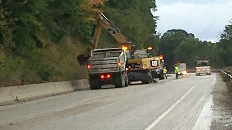 Crews clean up a mudslide that partially covered Highway 82 near De Soto in Crawford County on Wednesday