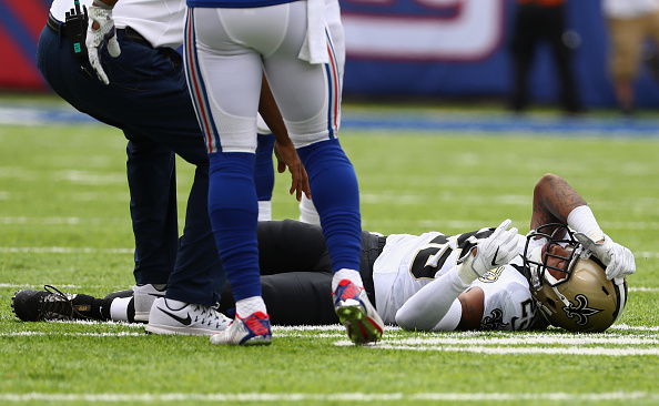 P.J. Williams #25 of the New Orleans Saints is tended to by medical staff after being injured