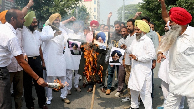 Congressmen protest against CM Parkash Badal Dy CM Sukhbir Badal and Speaker Charanjit Atwal in Amritsar on Tuesday | PTI