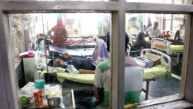 Patients lie in the fever ward at the Ram Manohar Lohiya Hospital in New Delhi