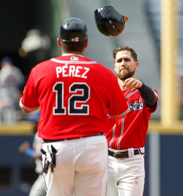 Atlanta Braves Ender Inciarte tosses his helmet to first base coach Eddie Perez after being tagged out in a double play to end the eighth inning of a baseball game in Atlanta Sunday Sept. 11 2016. The New York Mets defeated the Atlanta Braves 10-3. (AP