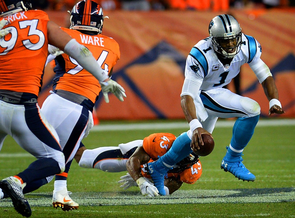 Denver CO USA- Carolina Panthers quarterback Cam Newton escapes the grasp of Denver Broncos safety T.J. Ward during the second quarter at Sports Authority Field at Mile High in Denver on Thursday Sept. 8 2016