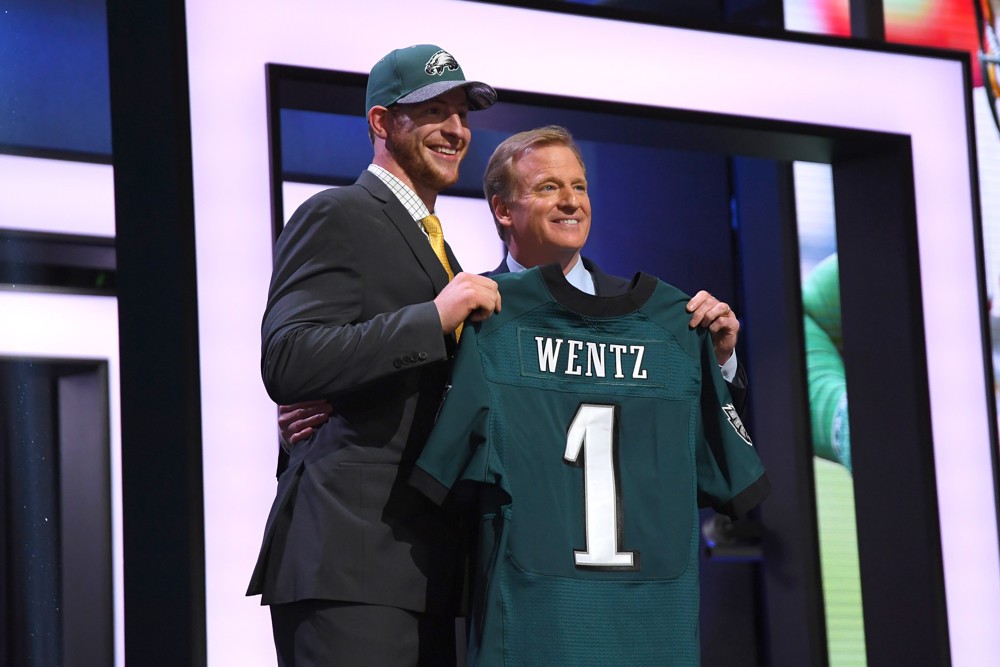 28 April 2016 North Dakota State's Carson Wentz walks on stage and poses with NFL Commissioner Roger Goodell after being drafted the number two pick by the Philladelphia Eagles in the first round of the 2016 NFL Draft held at the Auditorium Theatre