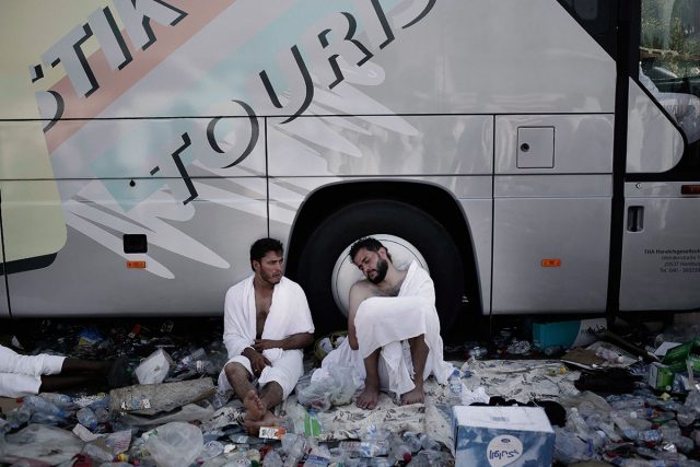 Muslim pilgrims rest in the shade of a bus on Sunday near Namira Mosque on the second day of the annual hajj pilgrimage in Arafat Saudi Arabia. AP