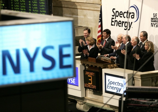 Executives of Fortune 500 firm Spectra Energy applaud as and New York Stock Exchange Chairman John Thain rings the bell on the year's first day of tradin