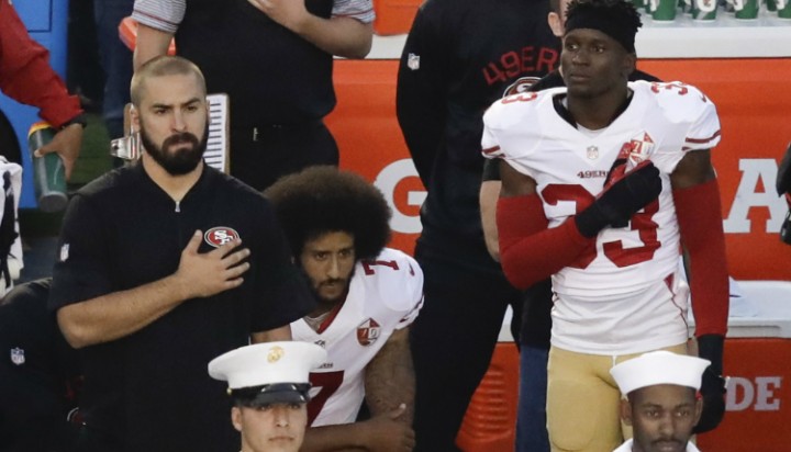 San Francisco 49ers quarterback Colin Kaepernick middle kneels during the national anthem before the team's NFL preseason football game against the San Diego Chargers Thursday Sept. 1 2016 in San Diego