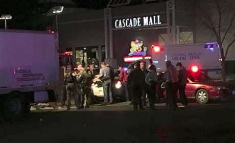 Law enforcement officers stand in front of the Macy's store at the Cascade Mall in Burlington Wash. where several people were fatally shot Friday Sept. 23 2016. Authorities in Washington State say several people have been killed during a shootin