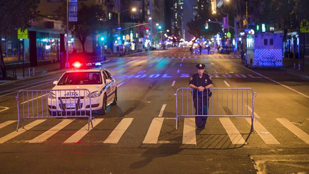 Police stand guard near the scene of the explosion