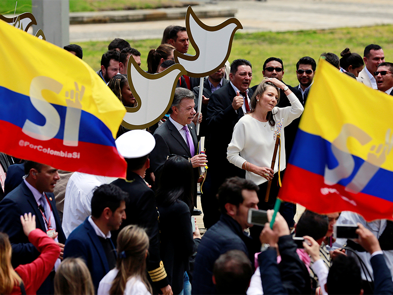 Colombian President Juan Manuel Santos center left and first lady Maria Clemencia de Santos arrive at the Colombian Congress in Bogota to present the FARC peace accord on Aug. 25 2016