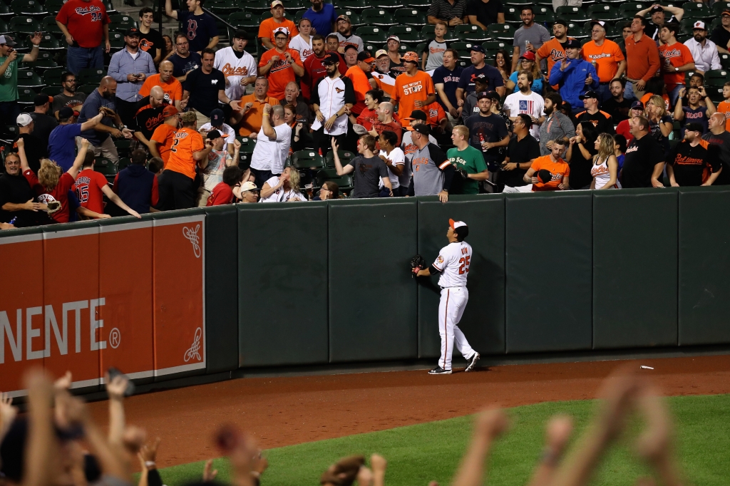 BALTIMORE MD- SEPTEMBER 19 Hyun Soo Kim #25 of the Baltimore Orioles follows a two RBI home run hit by Mookie Betts #50 of the Boston Red Sox during the third inning at Oriole Park at Camden Yards