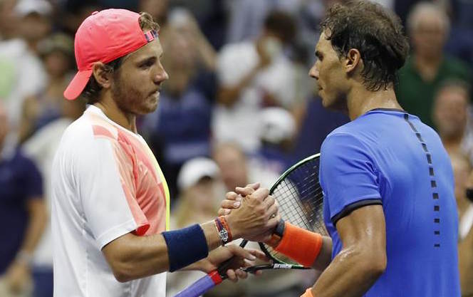 Lucas Pouille of France shakes hands with Rafael Nadal of Spain after winning their match during the fourth round of the U.S. Open tennis tournament Sunday Sept. 4 2016 in New York