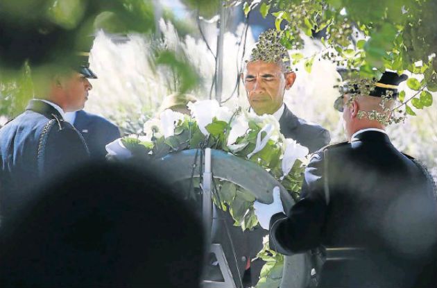 SOLEMN MOMENT US President Barack Obama lays a wreath during a ceremony to mark the 15th anniversary of the 9/11 terrorist attacks at the Pentagon Memorial in front of the Pentagon in Arlington Virginia