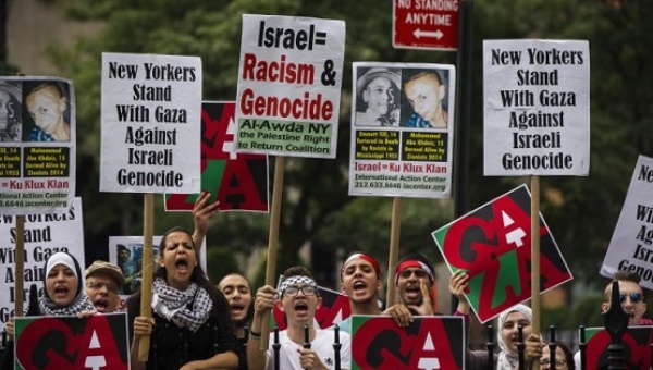 Pro-Palestinian demonstrators display signs outside of New York