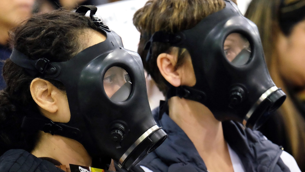 Protesters wear gas masks at a hearing over a leak at the Southern California Gas Co.'s Aliso Canyon Storage Facility near the Porter Ranch section of Los Angeles. On Tuesday the utility pleaded no contest to a misdemeanor and agreed to pay $4 milli