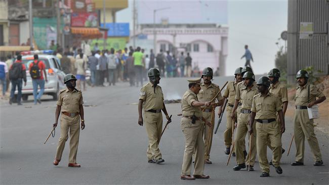 India's police personnel chase agitated pro Karnataka activists following the Supreme Court's order to release water to Tamil Nadu