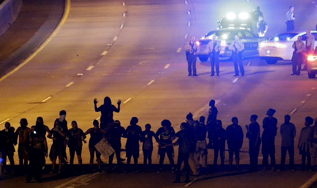 Protesters block I-277 during a third night of unrest following Tuesday's police shooting of Keith Lamont Scott in Charlotte N.C. Thursday Sept. 22 2016