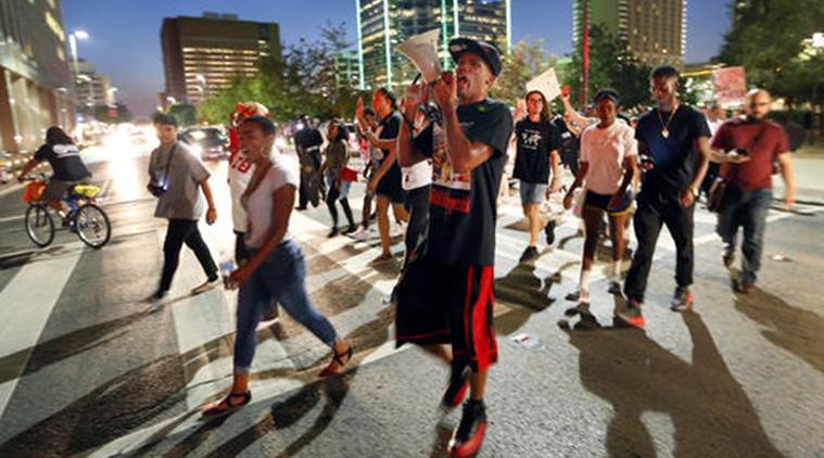 Protesters cross Commerce Street during the Generation Action Network protest in downtown Dallas Thursday