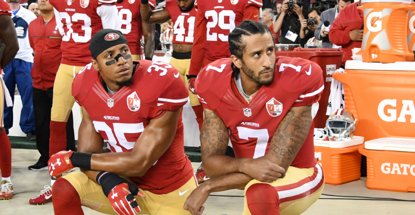 Colin Kaepernick #7 and Eric Reid #35 of the San Francisco 49ers kneel in protest during the national anthem prior to playing the Los Angeles Rams in their NFL game at Levi's Stadium