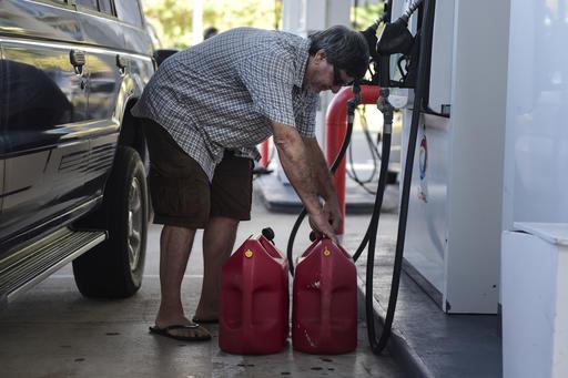 Edgardo Colon picks up his gas container after filling it with diesel for his generator in San Juan Puerto Rico Thursday Sept. 22 2016. Repair crews on Thursday worked to restore electricity to Puerto Rico’s 3.5 million people after a fire at a