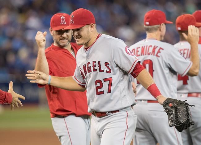 Los Angeles Angels&#39 Mike Trout celebrates with teammates after they defeated the Toronto Blue Jays in their American League MLB baseball game in Toronto on Thursday