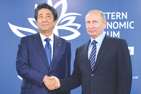 Russian President Vladimir Putin shakes hands with Japanese Prime Minister Shinzo Abe during a meeting on the sidelines of the Eastern Economic Forum in Vladivostok