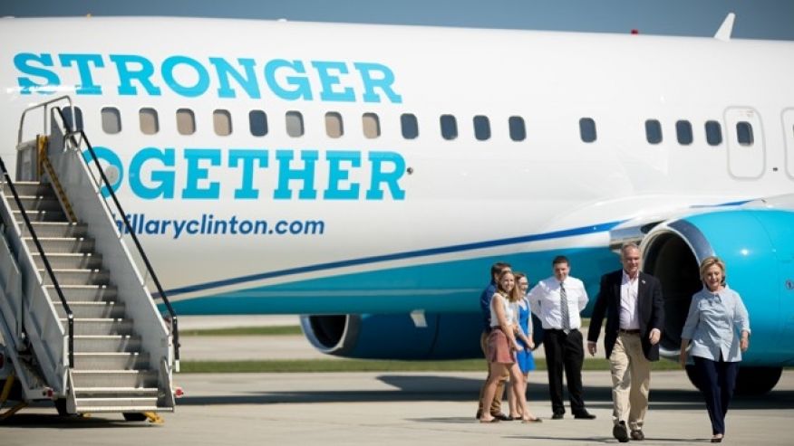 Democratic presidential candidate Hillary Clinton right accompanied by Democratic vice presidential candidate Sen. Tim Kaine D-Va. second from right walks across the tarmac as Clinton arrives at Cleveland Hopkins International Airport in Cleveland