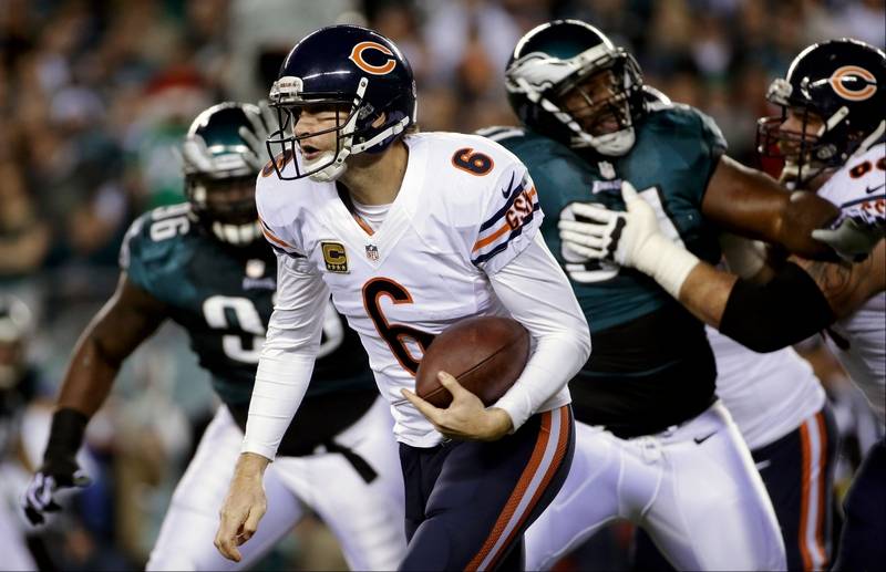 Quarterback Jay Cutler is chased by Eagles players on Dec. 22 2013